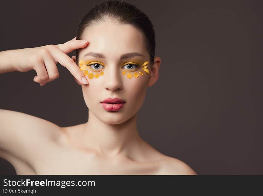 Spa portrait of a young woman. Flowers on her face. The concept of skin and body care. Perfect skin health