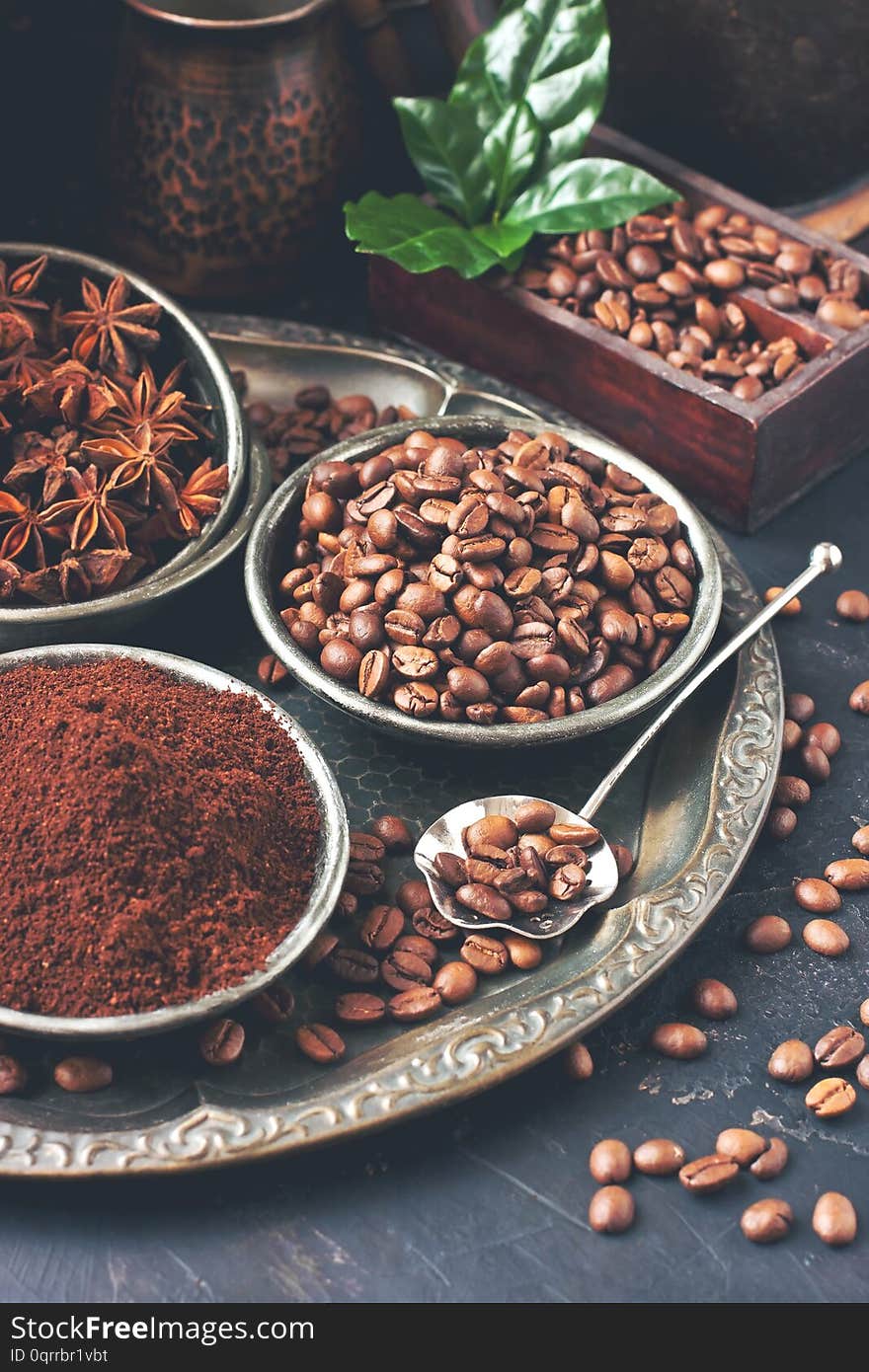 Roasted coffee beans with green leaves, toned photo