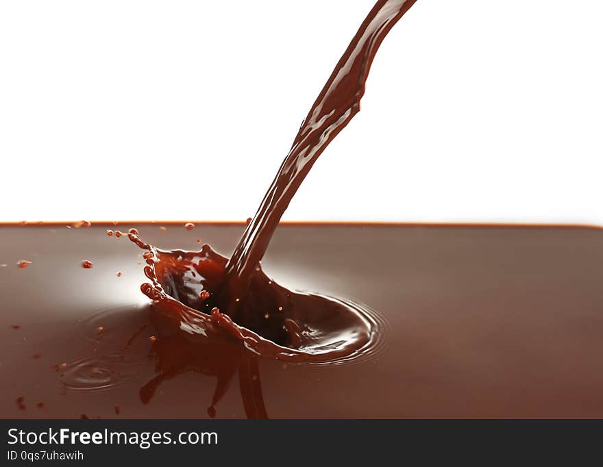 Pouring of cocoa on white background