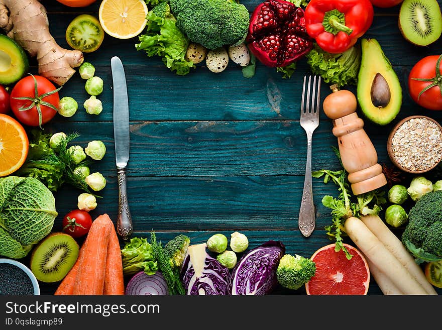 Healthy organic food on a blue wooden background. Vegetables and fruits. Top view. Free copy space
