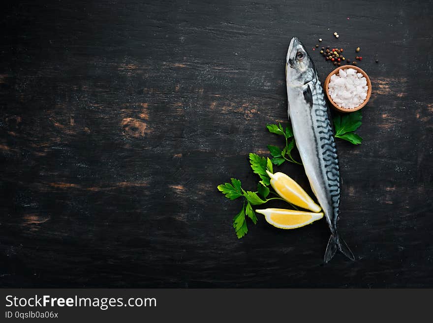 Fish. Raw Mackerel on a black wooden background.