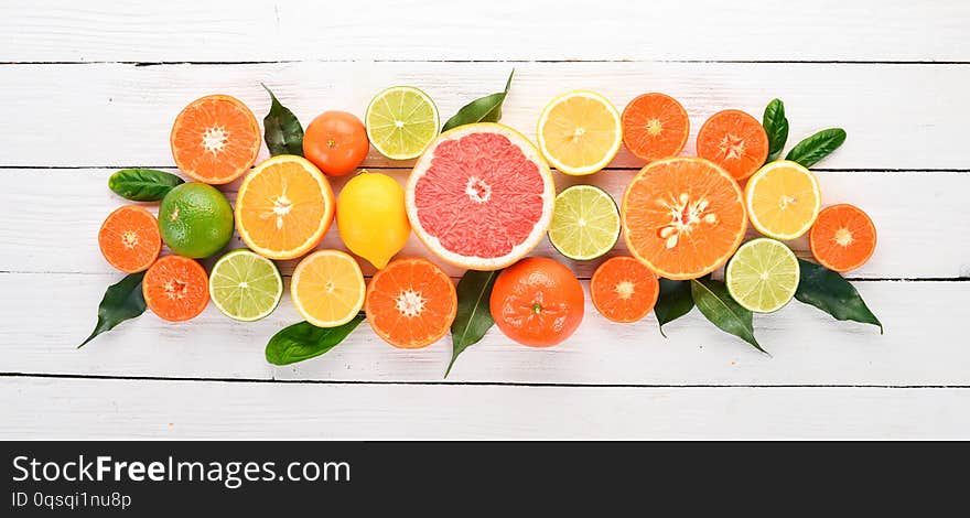 A set of citrus fruit. Orange, tangerine, grapefruit, lemon. On a wooden background. Top view. Copy space