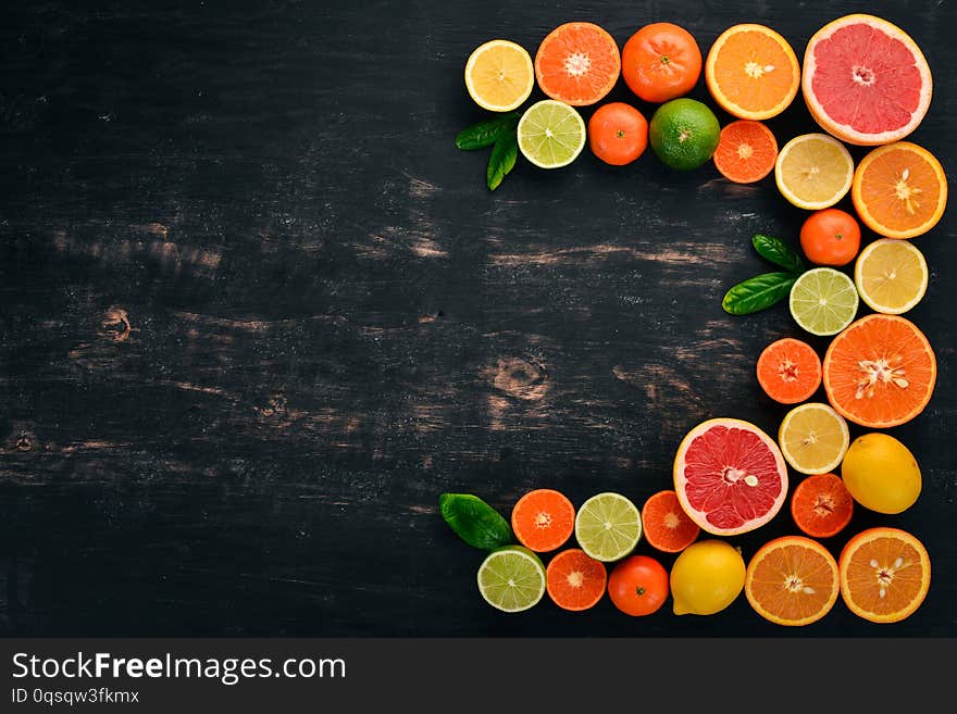 A set of citrus fruit. Orange, tangerine, grapefruit, lemon. On a wooden background. Top view. Copy space