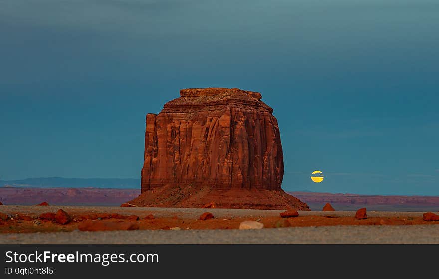 Monument Valley, Fullmoon in spring. Red rocks against blue sky in the evening. Navajo Tribal Park in the Arizona-Utah border, United States of America. Monument Valley, Fullmoon in spring. Red rocks against blue sky in the evening. Navajo Tribal Park in the Arizona-Utah border, United States of America