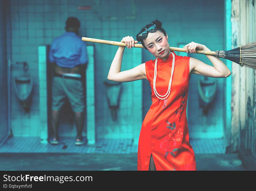 Chinese standing infront of male toilet waiting to clean the dirty toilet