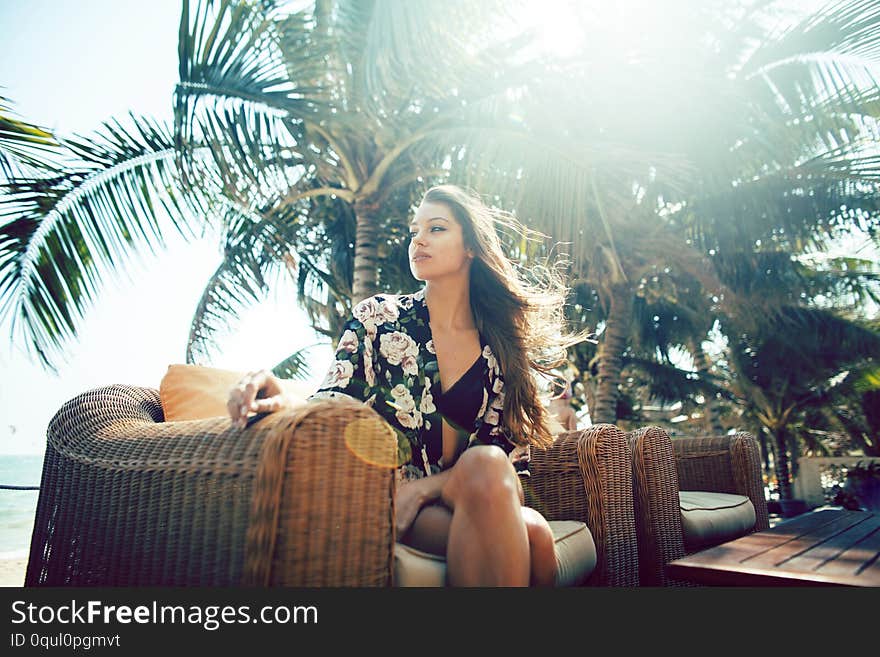 Young pretty woman at swimming pool relaxing in chair, fashion look in lingerie at hotel, lifestyle people concept closeup