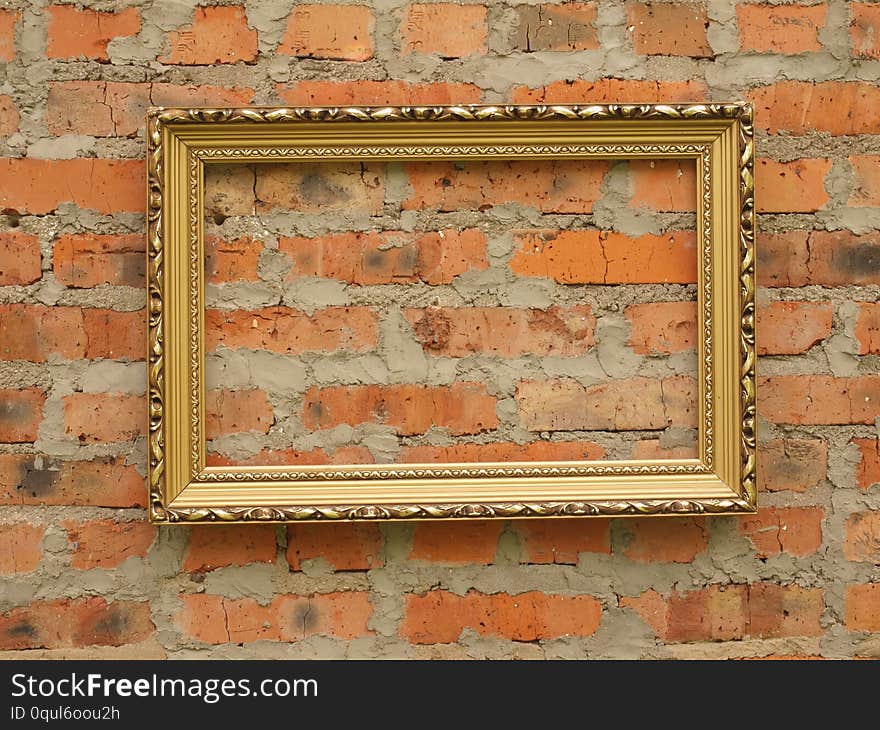 Picture frame from baguette on the background of an old brick wall.