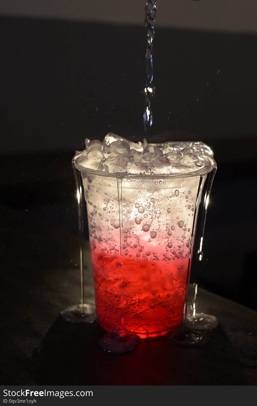 Close up short of strawberry italian soda on wooden table