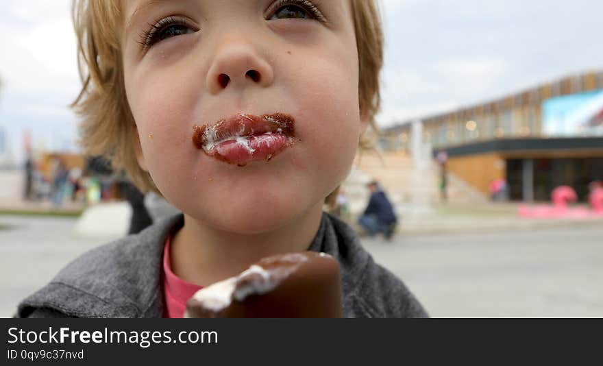 Happy child drinks milk from a cup