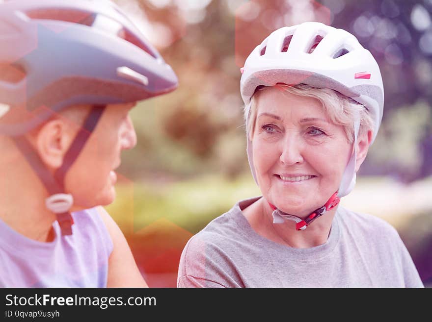 Senior Woman Wearing Cycling Helmet While Looking At Man