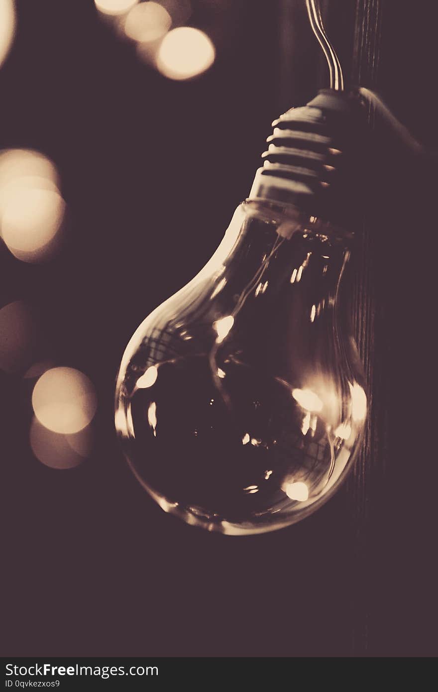 Image of glowing light bulb on dark background