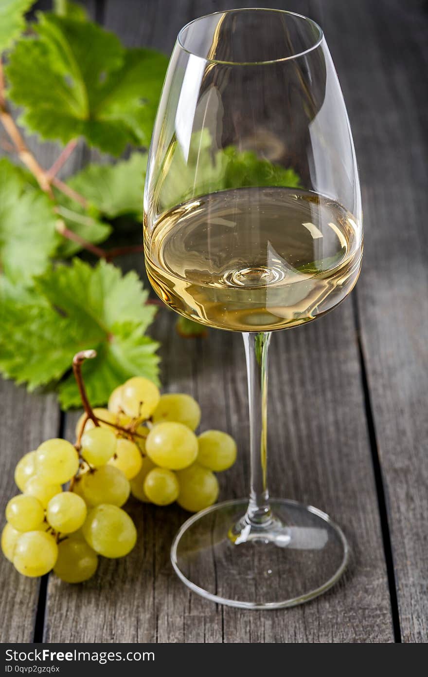 White Wine In A Glass And A Bunch Of Grapes