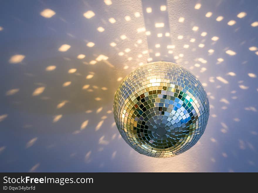 A Mirror disco ball hanging from the ceiling. A Mirror disco ball hanging from the ceiling