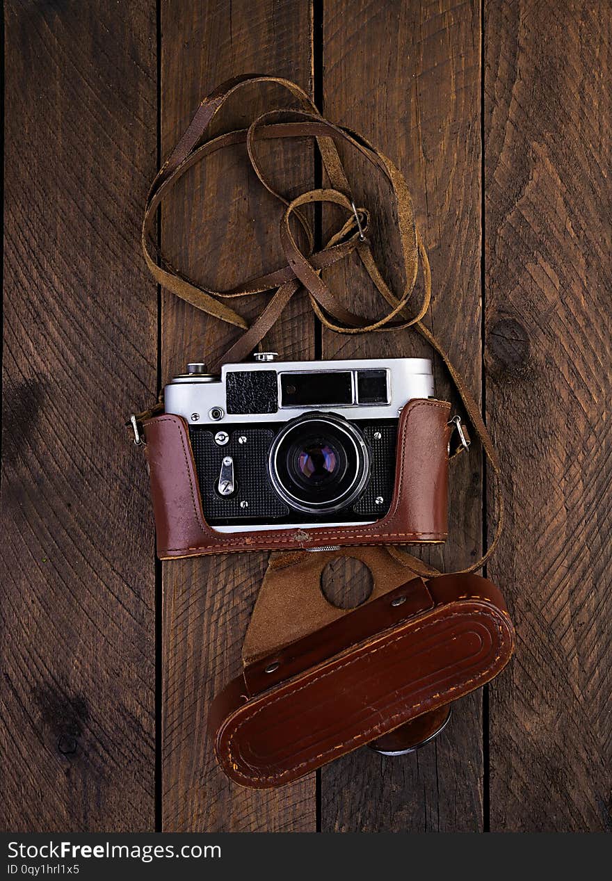 Vintage old camera with hearts on rustic wooden background. Vintage old camera with hearts on rustic wooden background.