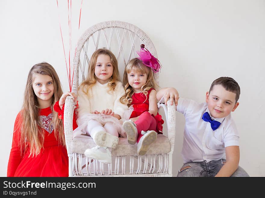 Kids are beautiful girls and the boy are sitting together