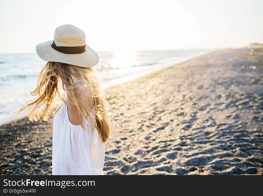 Young attractive long haired girl at the beach.