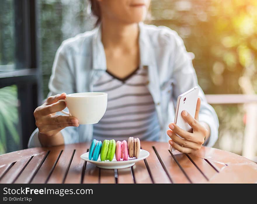 Valentine macaroons with coffee on wooden table. Toned image