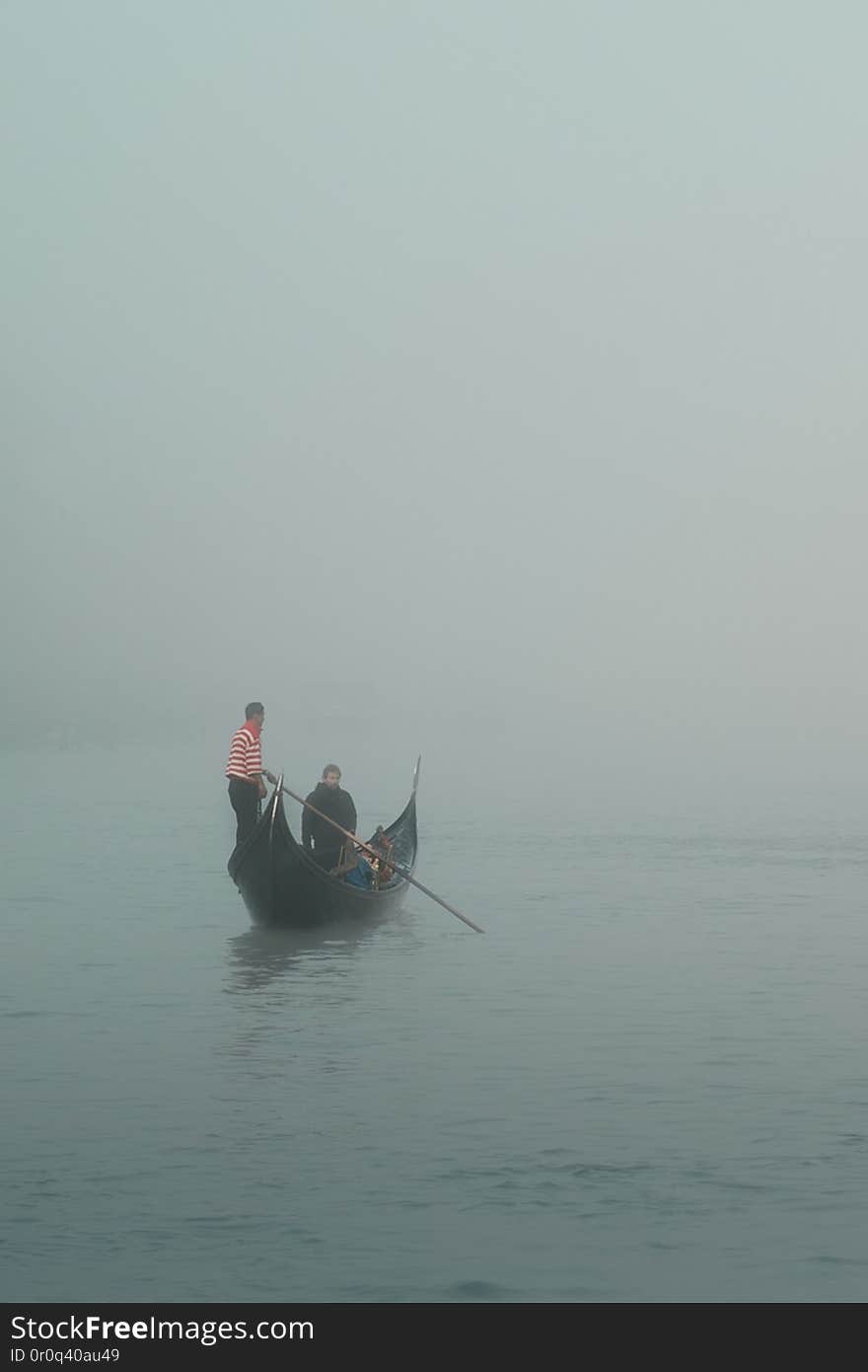 a foggy morning in venice and a lonely gondola on the canal. a foggy morning in venice and a lonely gondola on the canal.