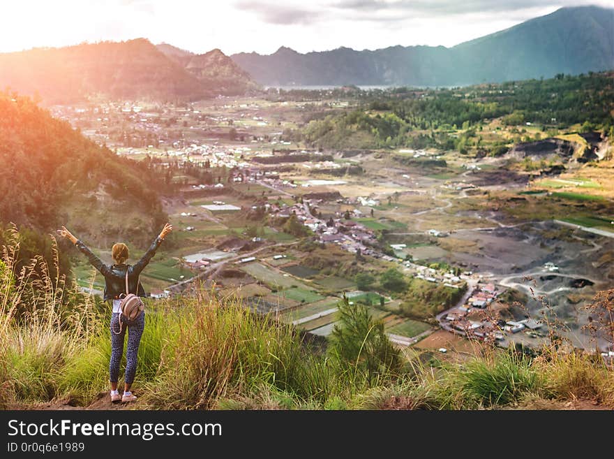 Woman standing on mountain in morning. Bali island. Indonesia. Woman standing on mountain in morning. Bali island. Indonesia.