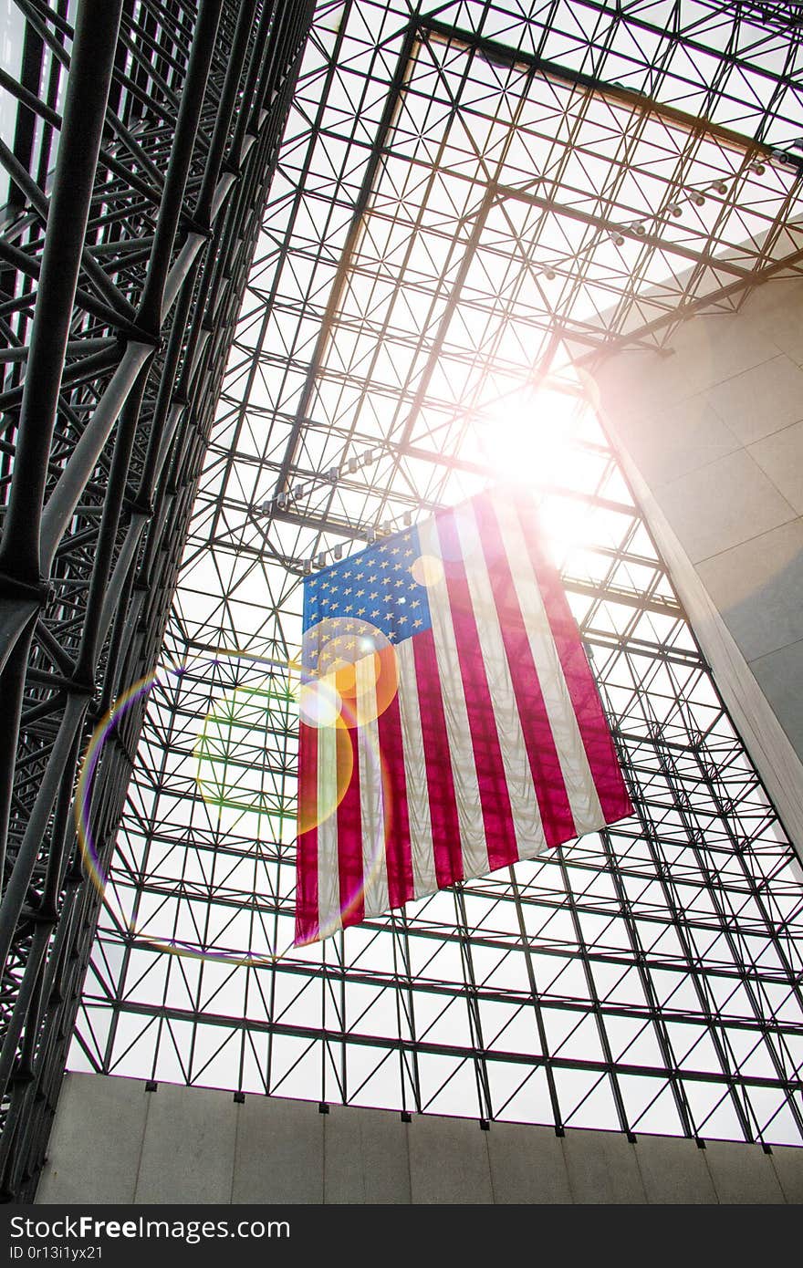 United states flag hanging inside of a building