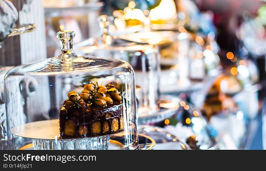 Delicious cake with peanut butter cream layer and chocolate topping. Bakery shop background. Selective focus