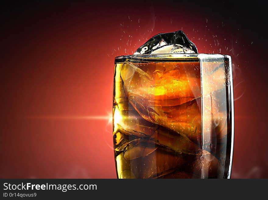 Soft drink glass with ice splash on cool smoke background. Cola glass with summer refreshment