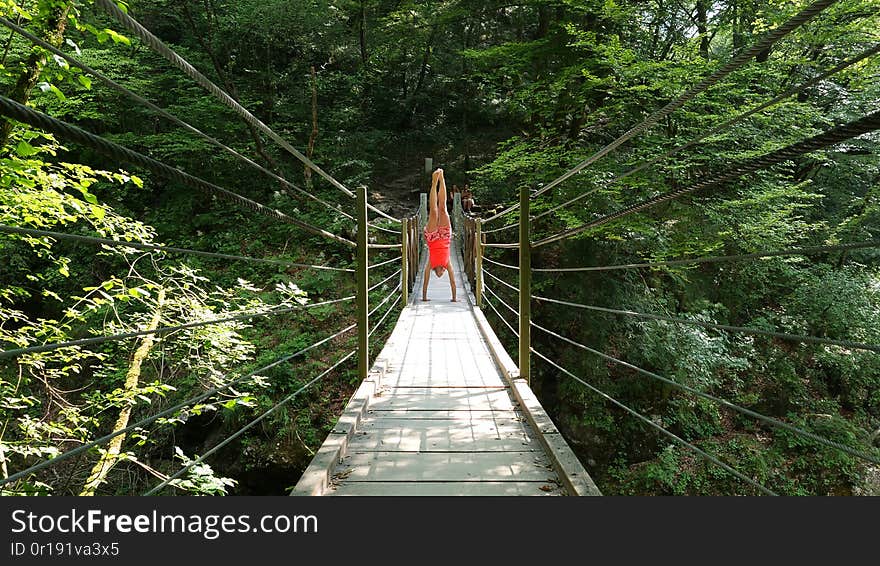 Woman in wooden suspension bridge in slovenia