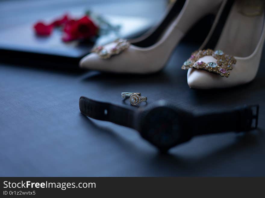 Close up macro photo a pair of rings for weeding in traditional way in Cambodia. Close up with rose in the background.