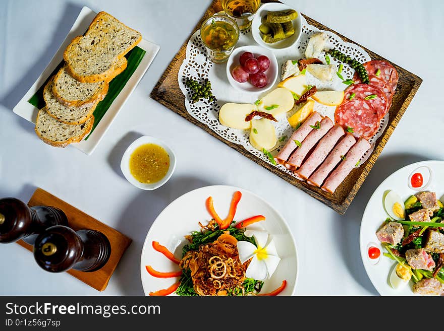 Overhead of cheese platter with crispy toasts. Food and beverage.