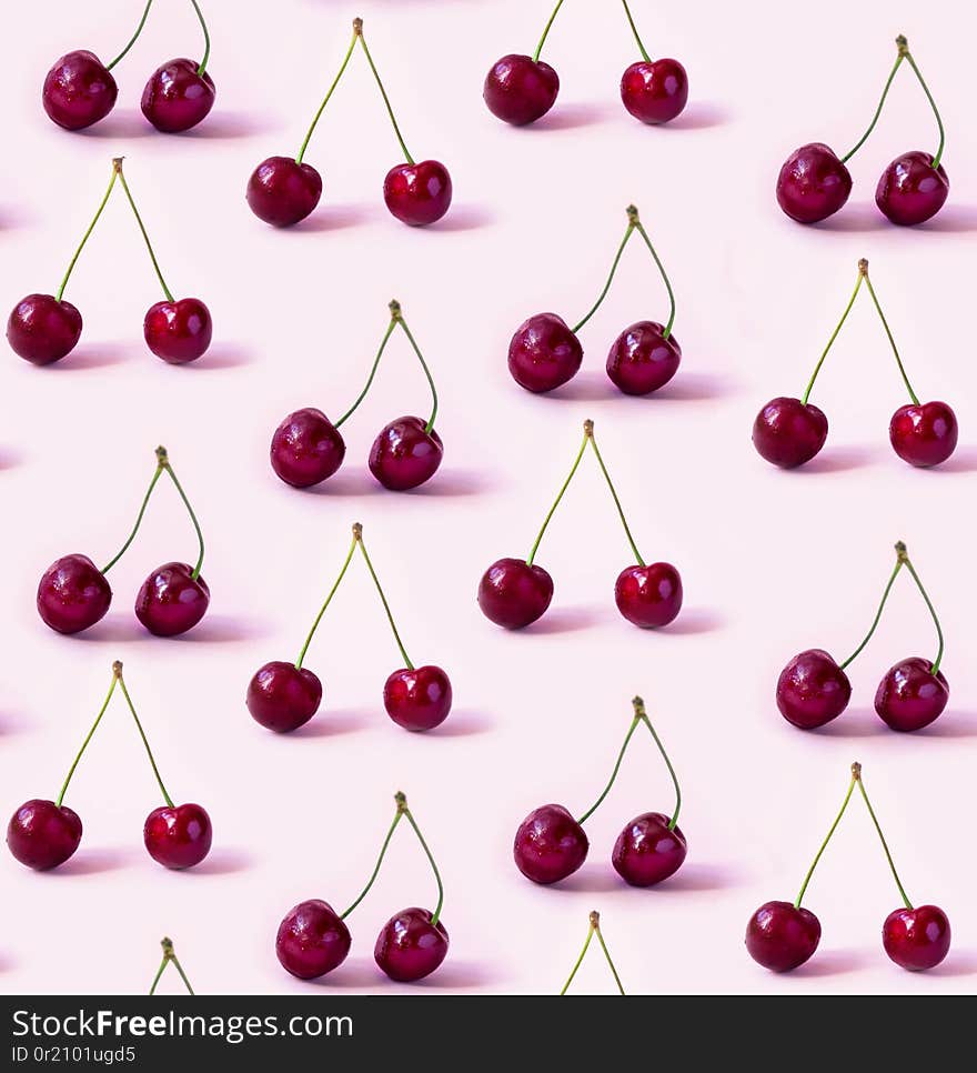 Seamless pattern. Red Cherries on a pink background. Seamless pattern. Red Cherries on a pink background