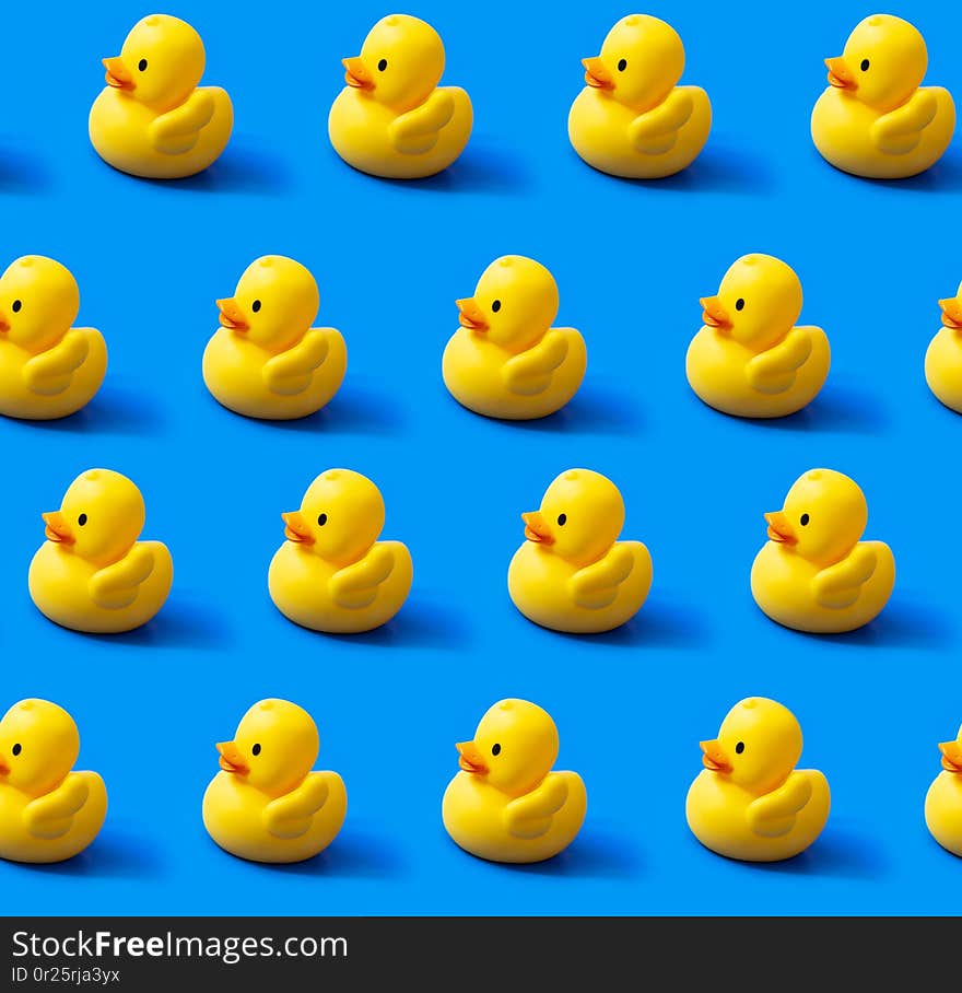 Seamless endless repeating pattern. Rubber yellow ducks on a blue background. Seamless endless repeating pattern. Rubber yellow ducks on a blue background