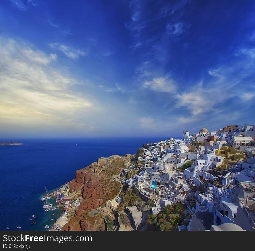 Blue and white colours of Oia City. Magnificent panorama of the island of Santorini Greece during a beautiful sunset in the Mediterranean. Love and travel background