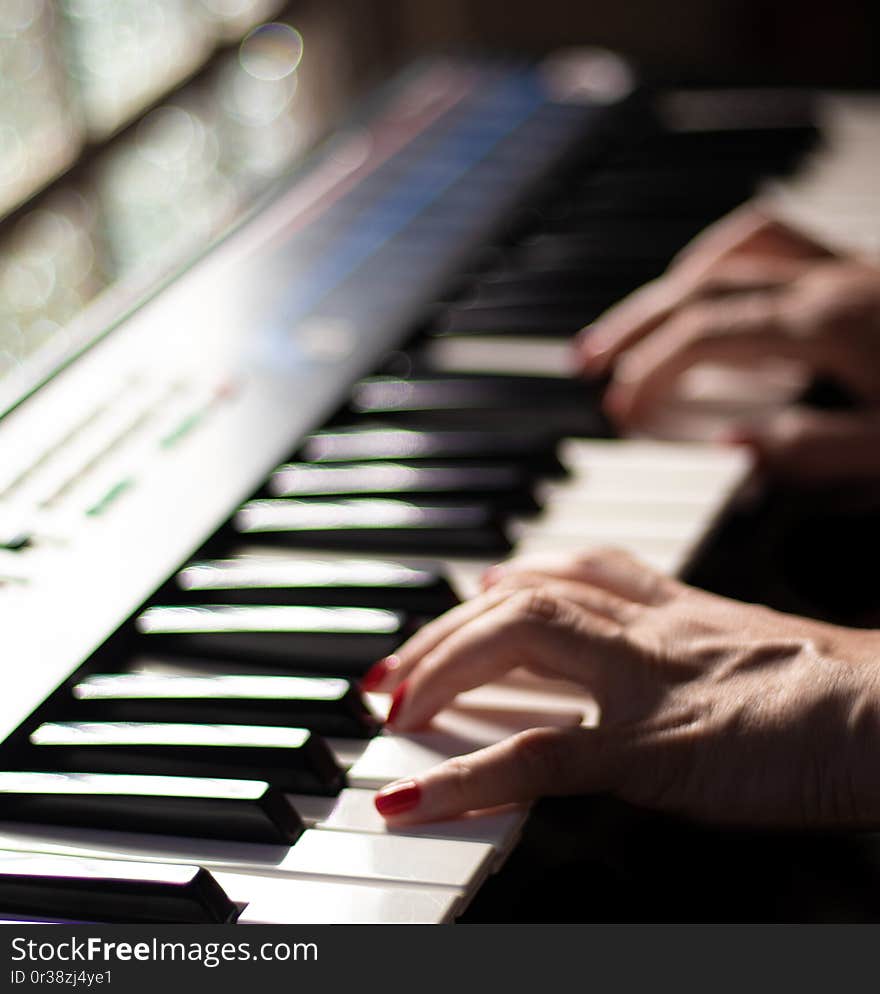 A beautiful scene of a woman playing music with a beautiful casio keyboard. A beautiful scene of a woman playing music with a beautiful casio keyboard.