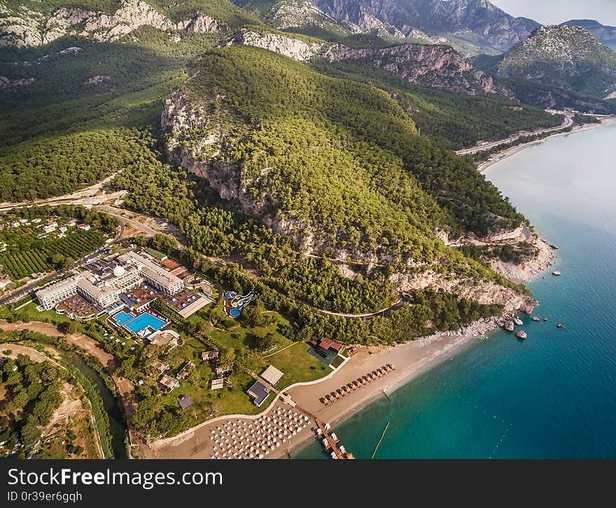 Aerial view on the coastline, mountains, road, tunel and hotels, in vicinities of Kemer and settlement of Beldibi, Turkey. Aerial view on the coastline, mountains, road, tunel and hotels, in vicinities of Kemer and settlement of Beldibi, Turkey