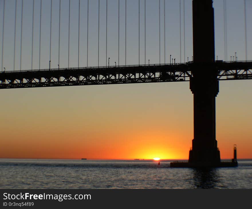 The Golden Gate Bridge is a suspension bridge spanning the Golden Gate, the one-mile-wide &#x28;1.6 km&#x29; strait connecting San Francisco Bay and the Pacific Ocean. The structure links the American city of San Francisco, California – the northern tip of the San Francisco Peninsula – to Marin County, carrying both U.S. Route 101 and California State Route 1 across the strait. The bridge is one of the most internationally recognized symbols of San Francisco, California, and the United States. It has been declared one of the Wonders of the Modern World by the American Society of Civil Engineers. The Golden Gate Bridge is a suspension bridge spanning the Golden Gate, the one-mile-wide &#x28;1.6 km&#x29; strait connecting San Francisco Bay and the Pacific Ocean. The structure links the American city of San Francisco, California – the northern tip of the San Francisco Peninsula – to Marin County, carrying both U.S. Route 101 and California State Route 1 across the strait. The bridge is one of the most internationally recognized symbols of San Francisco, California, and the United States. It has been declared one of the Wonders of the Modern World by the American Society of Civil Engineers.