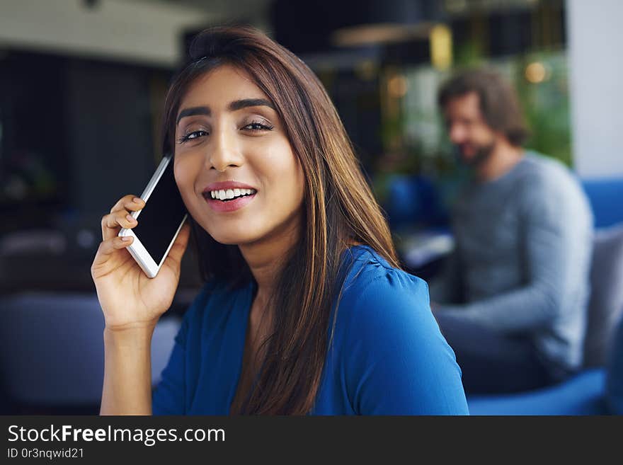 Waist up of Asian woman on the phone