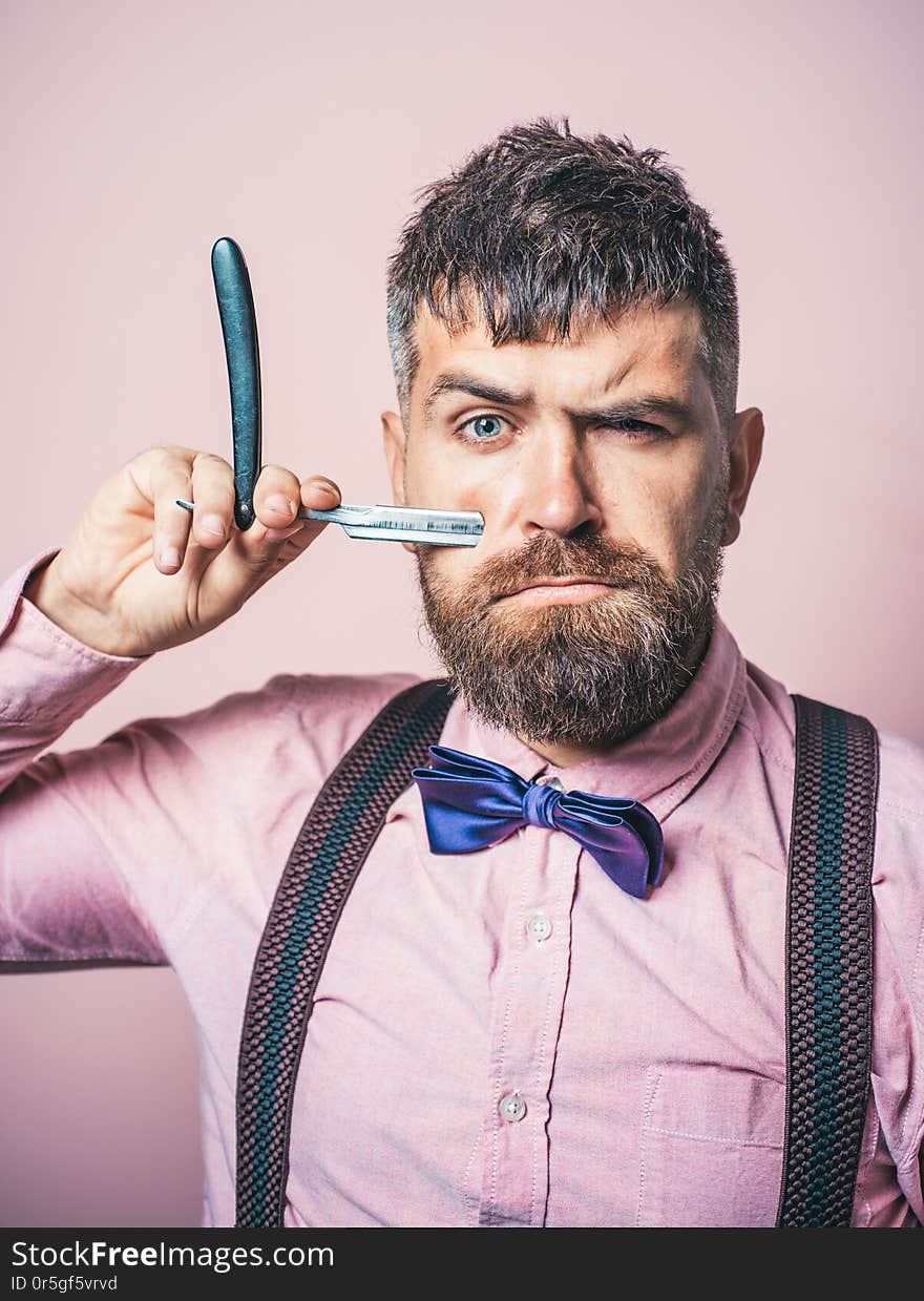 Bearded man. Male fashion. Portrait of stylish man with beard. Barber scissors and straight razor. Barber shop. Vintage barbershop, shaving