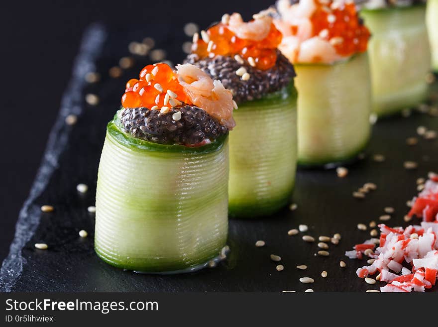 Rolls covered in cucumber with caviar and prawn.