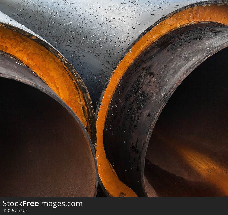 Stack of new gray metal pipes tubes. Fluid conveyance. Pipeline construction