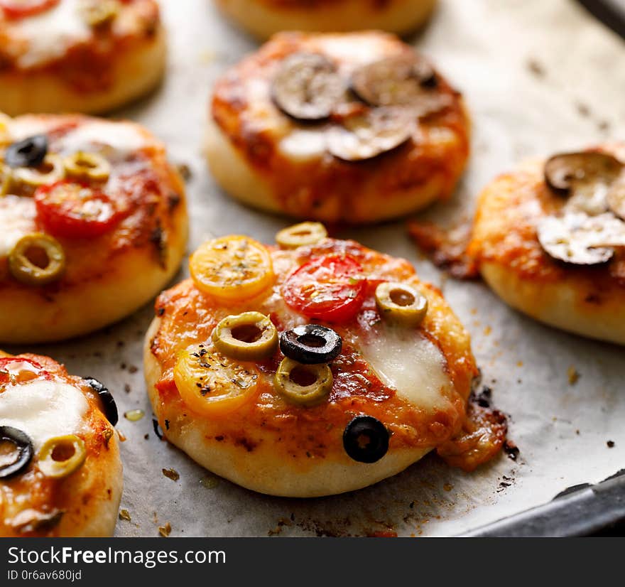 Small vegetarian pizzas with the addition various kinds of vegetables and mozzarella cheese and fresh basil