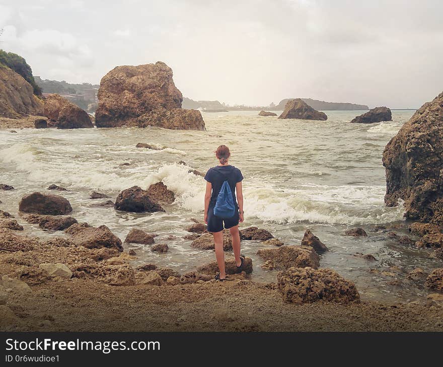 Girl looking at stormy sea