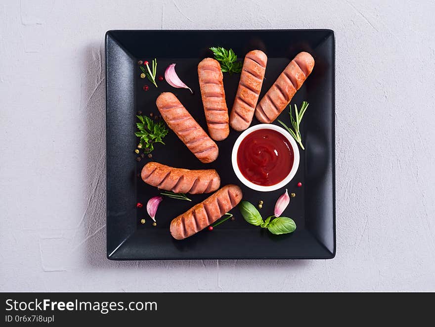 Fried sausages with herbs , spices and ketchup