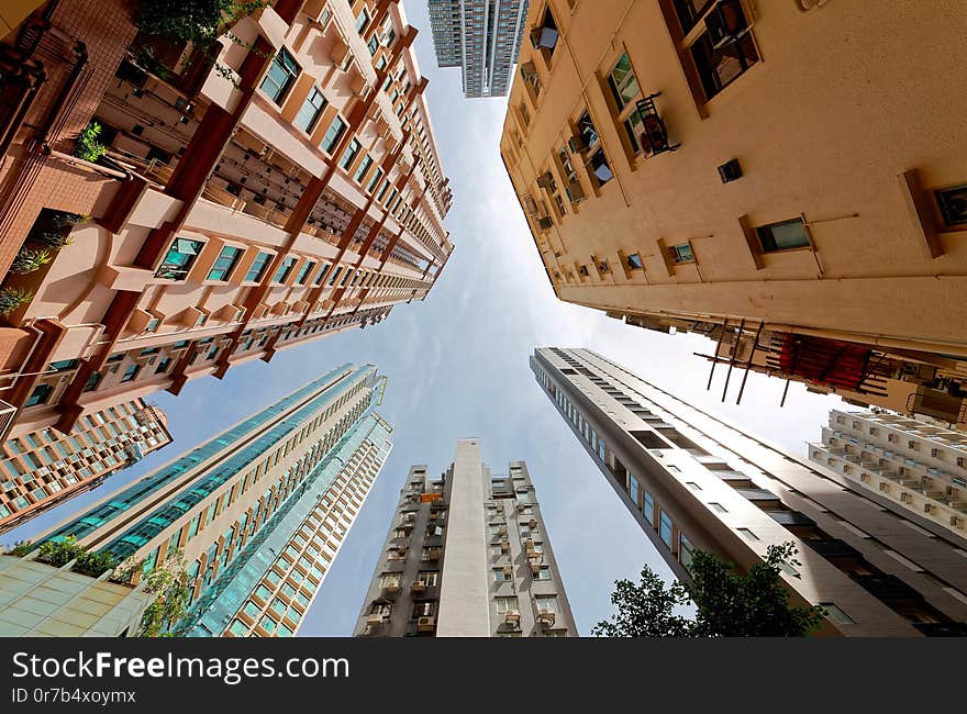 Low angle view of high-rise residential towers with crowded narrow apartments in a community near Central-Mid-Levels Escalator & Walkway system in Hong Kong, a phenomenon of severe housing shortage