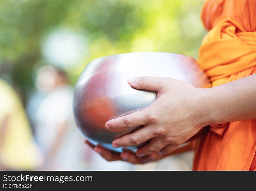 Monk with hand holding give alms bowl which came out of the offerings in the morning at Buddhist temple, Culture Heritage Site tradition and Religion Buddhism ,South east asia.