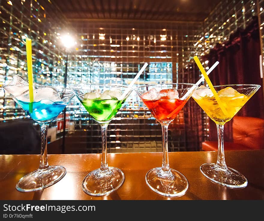 Multicolored tasty cocktails at the wooden bar.