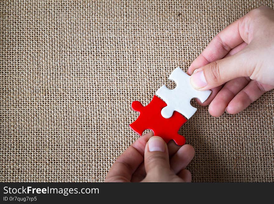 Closeup hand of man connecting jigsaw puzzle with sunlight effect, Business solutions, success and strategy concept.