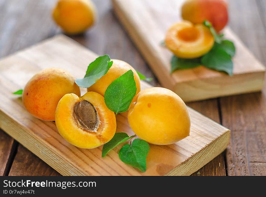 Ripe apricots beautifully lying on natural boards.