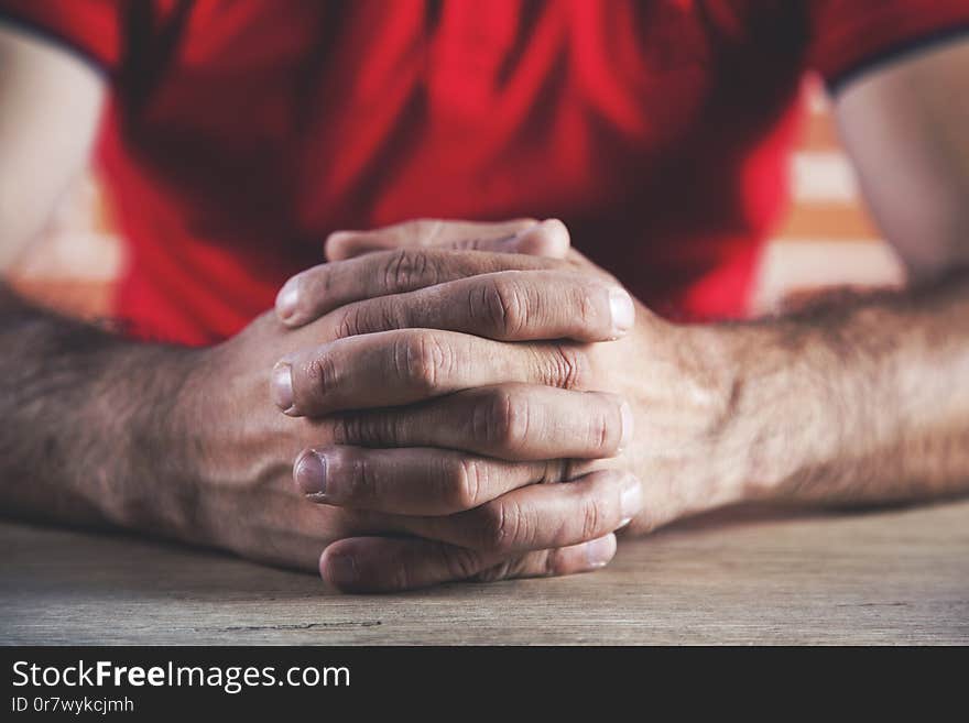 Man Crossed Finger On Desk