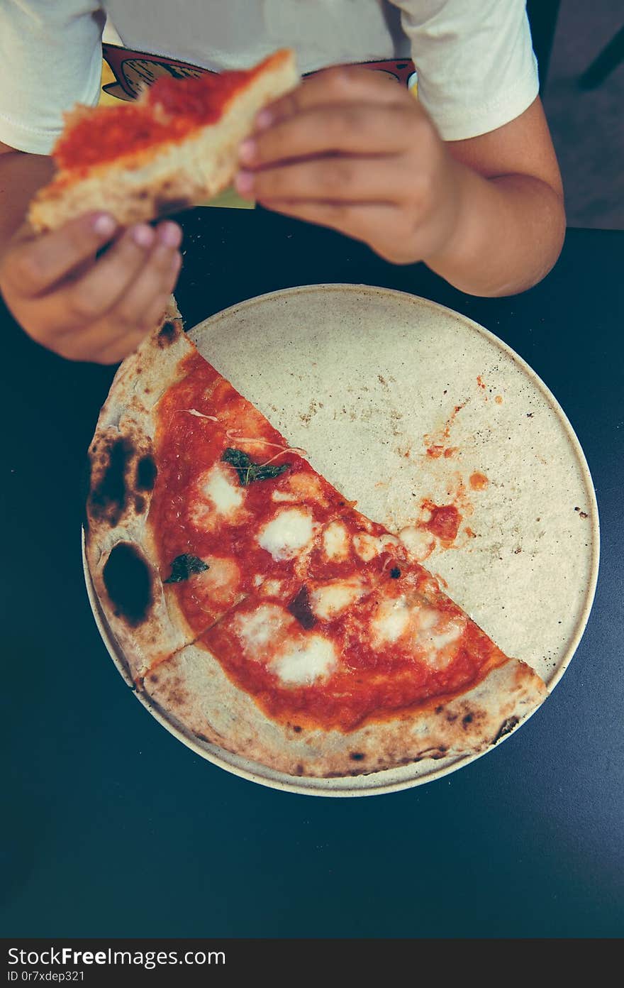 High angle shot of unrecognizable people`s hand grabbing a slice of pizza