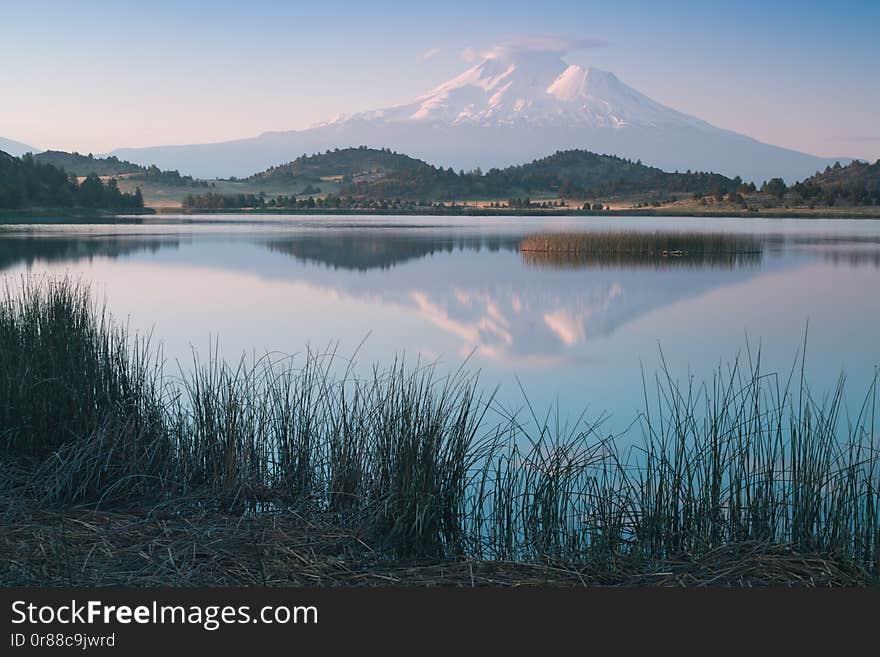 A reflection of snow capped Mount Shasta in a clear water in lake  at sunrise in California State, USA. 
Mount Shasta is a volcano at the southern end of the Cascade Range in Siskiyou County. A reflection of snow capped Mount Shasta in a clear water in lake  at sunrise in California State, USA. 
Mount Shasta is a volcano at the southern end of the Cascade Range in Siskiyou County